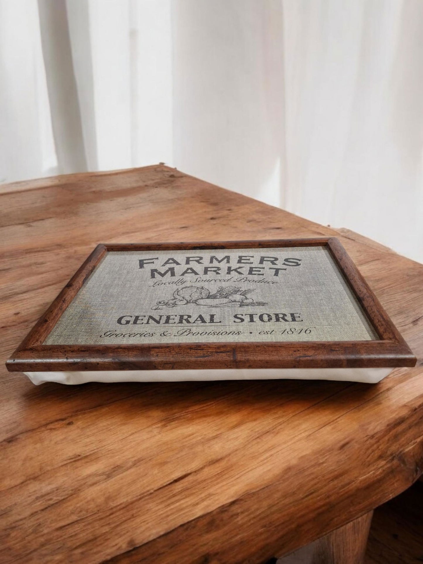 Framed print lap tray of a vintage general store design, featuring a building illustration, "Groceries & Provisions," and "est. 1846".