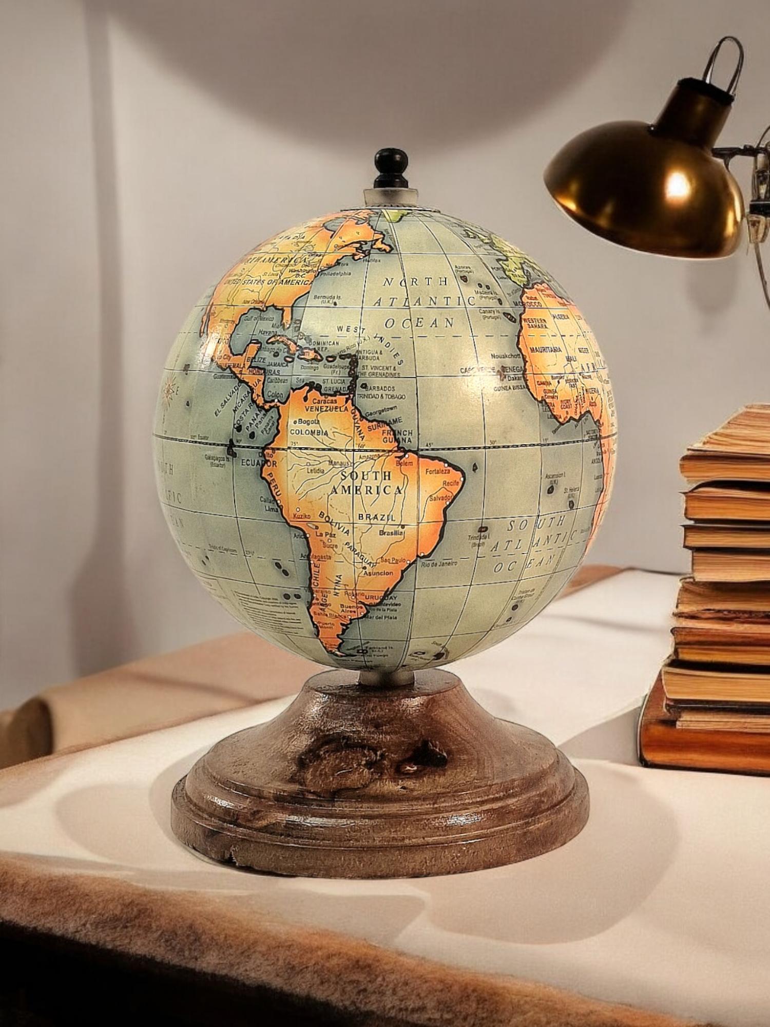 Vintage-style globe on a wooden stand, depicting continents and oceans with detailed labeling.