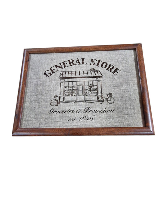 Framed print lap tray of a vintage general store design, featuring a building illustration, "Groceries & Provisions," and "est. 1846".