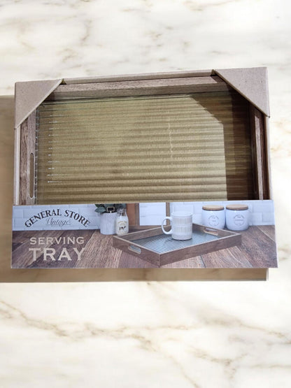 Wooden serving tray with a light grey/beige textured glass surface, displayed on a wooden surface.
