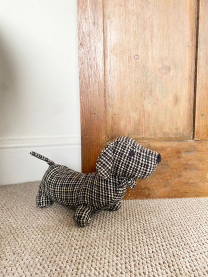 Fabric sausage dog doorstop in a grey and black herringbone pattern