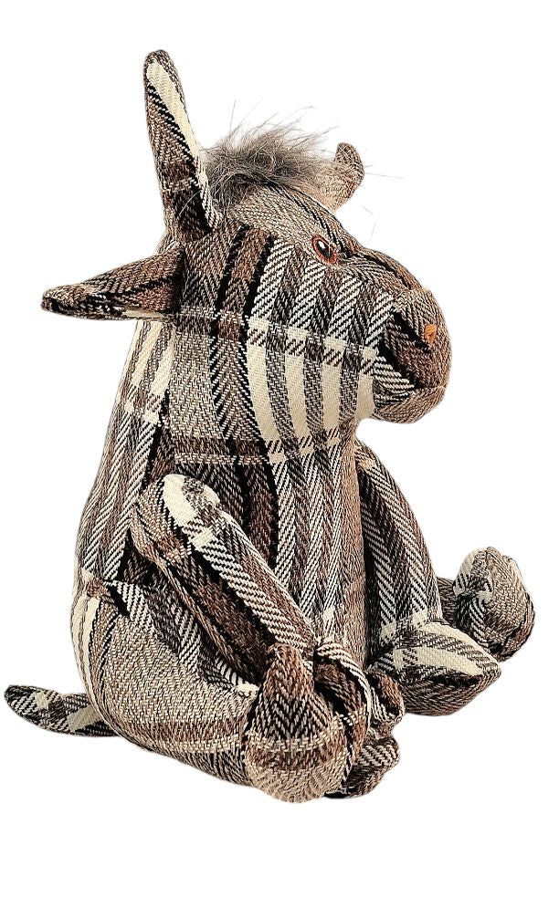 Grey tartan fabric bull doorstop with soft horns and button eyes, used as a charming and functional home decor accessory